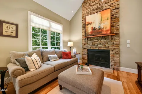 a living room with furniture a window and a fireplace