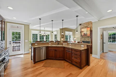 a living room with furniture a large window and a fireplace