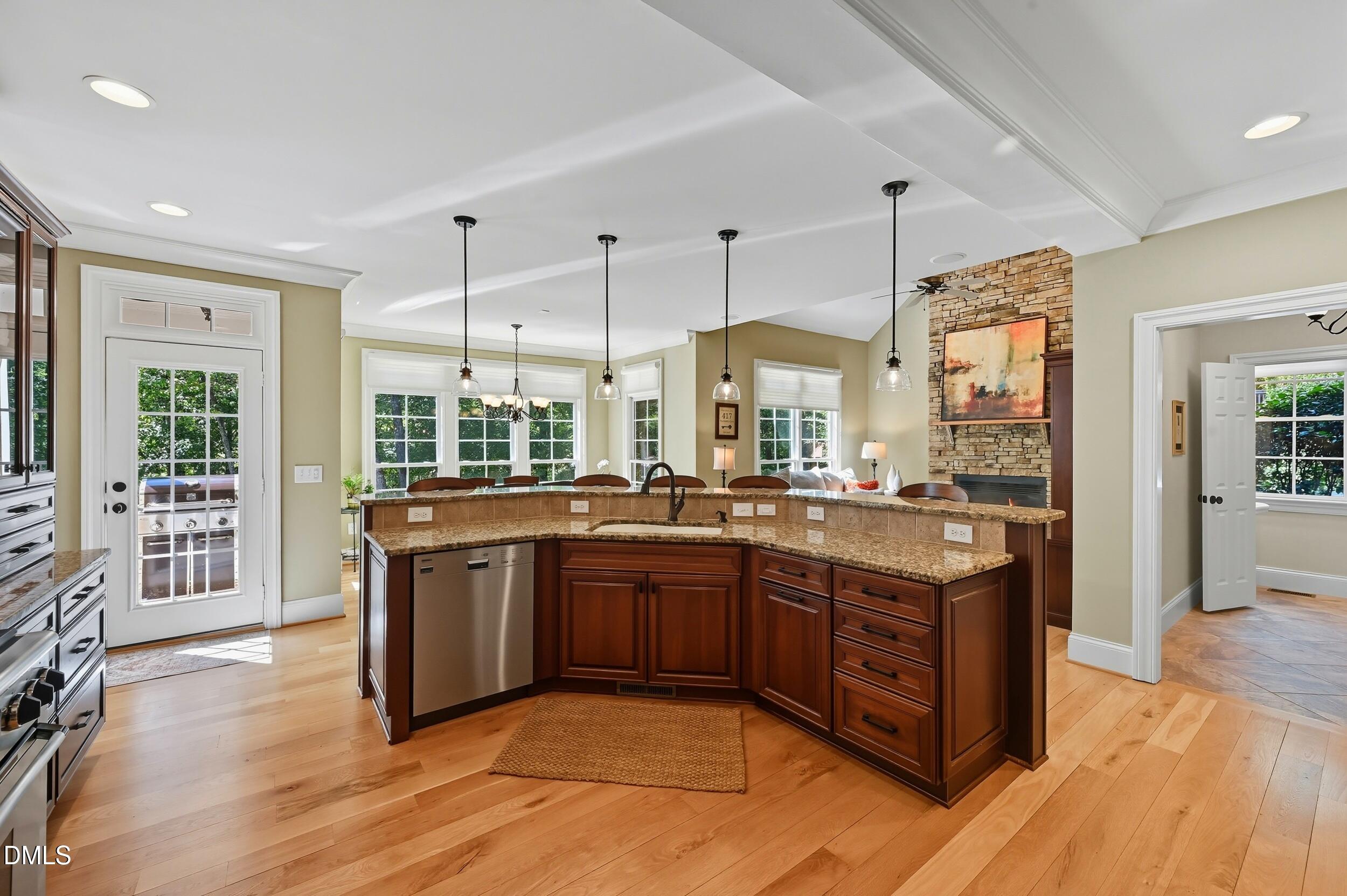 417 The Preserve Trail Chapel Hill, NC 27517 - Photo 19 of 83 a large kitchen with stainless steel appliances granite countertop a large kitchen island a stove a sink a refrigerator and white cabinets with wooden floor