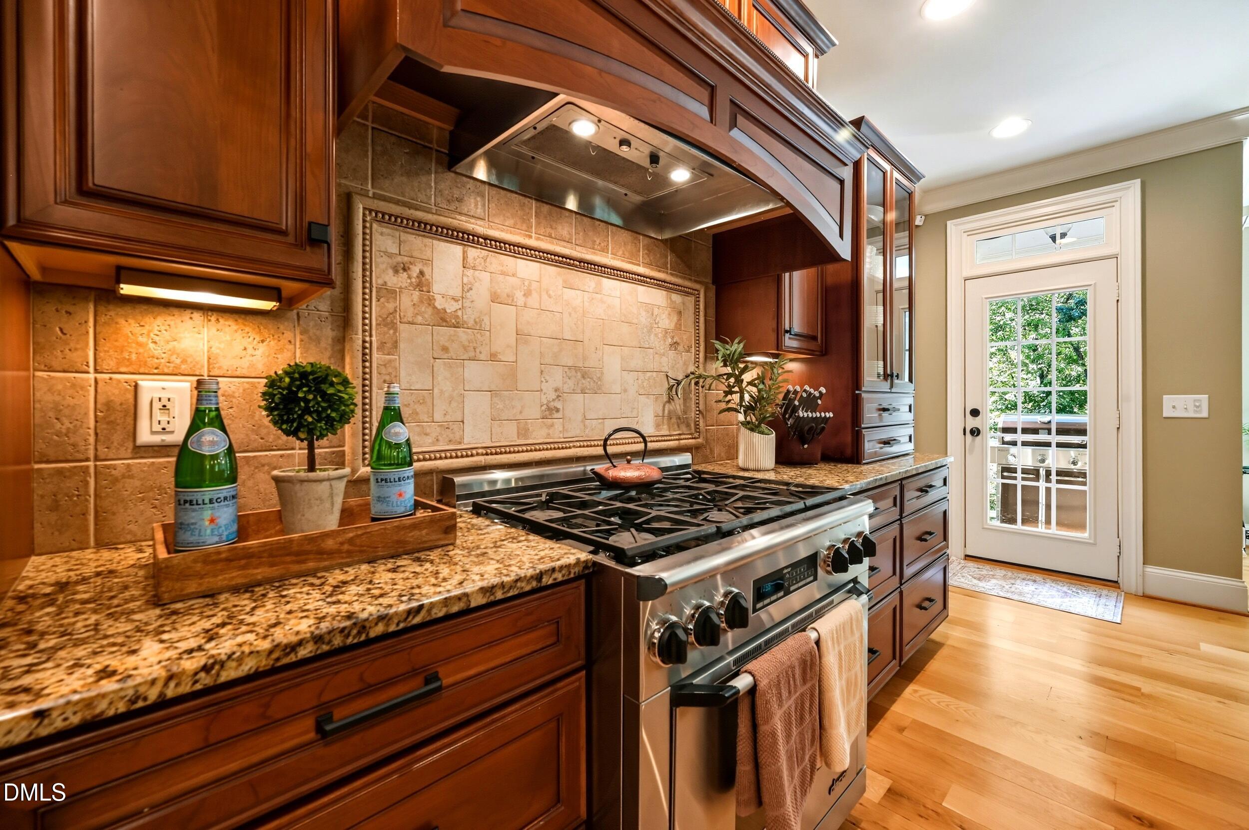 417 The Preserve Trail Chapel Hill, NC 27517 - Photo 21 of 83 a kitchen with stainless steel appliances granite countertop a stove a sink and a microwave