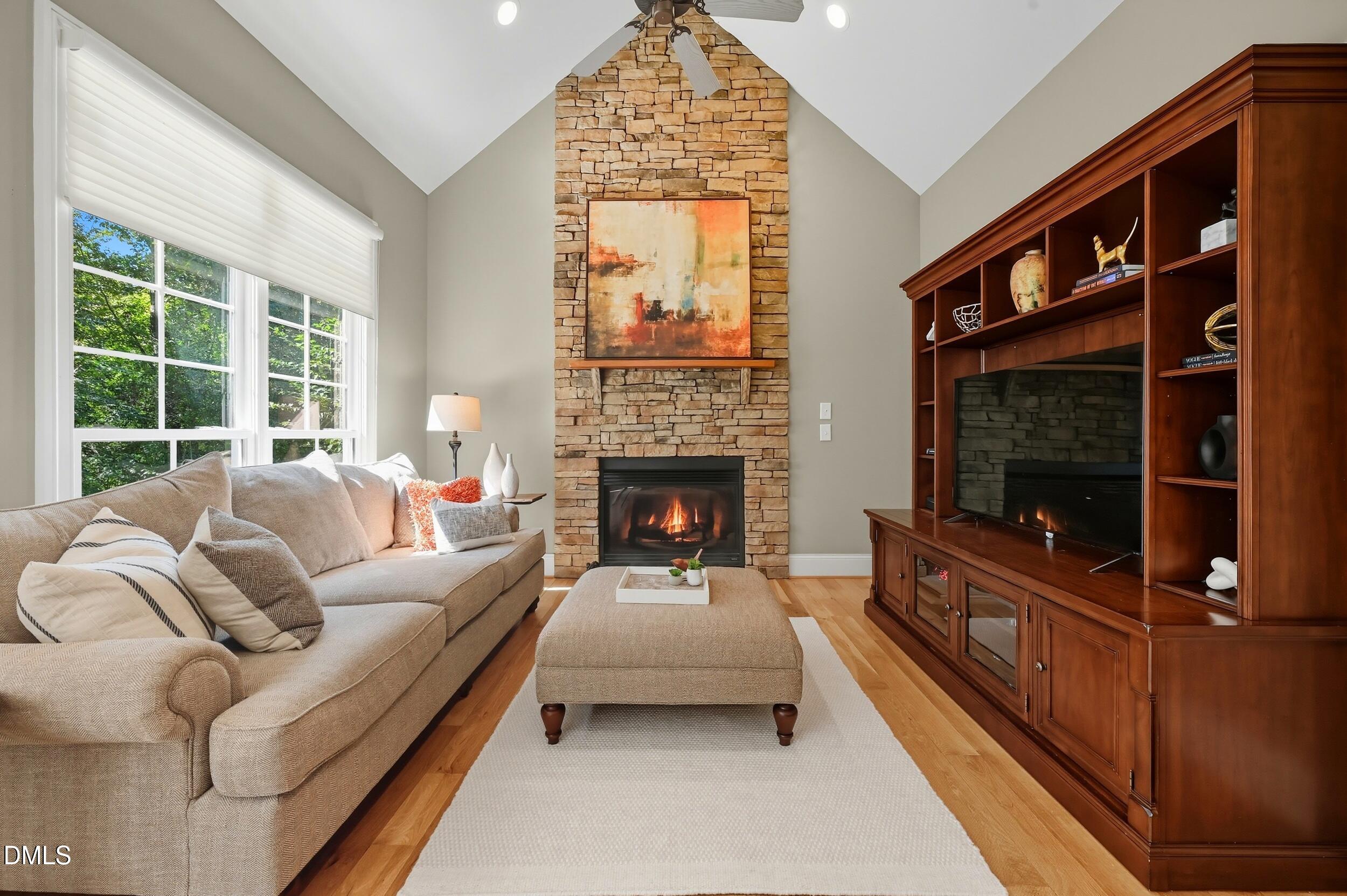 417 The Preserve Trail Chapel Hill, NC 27517 - Photo 26 of 83 a living room with furniture a window and a fireplace