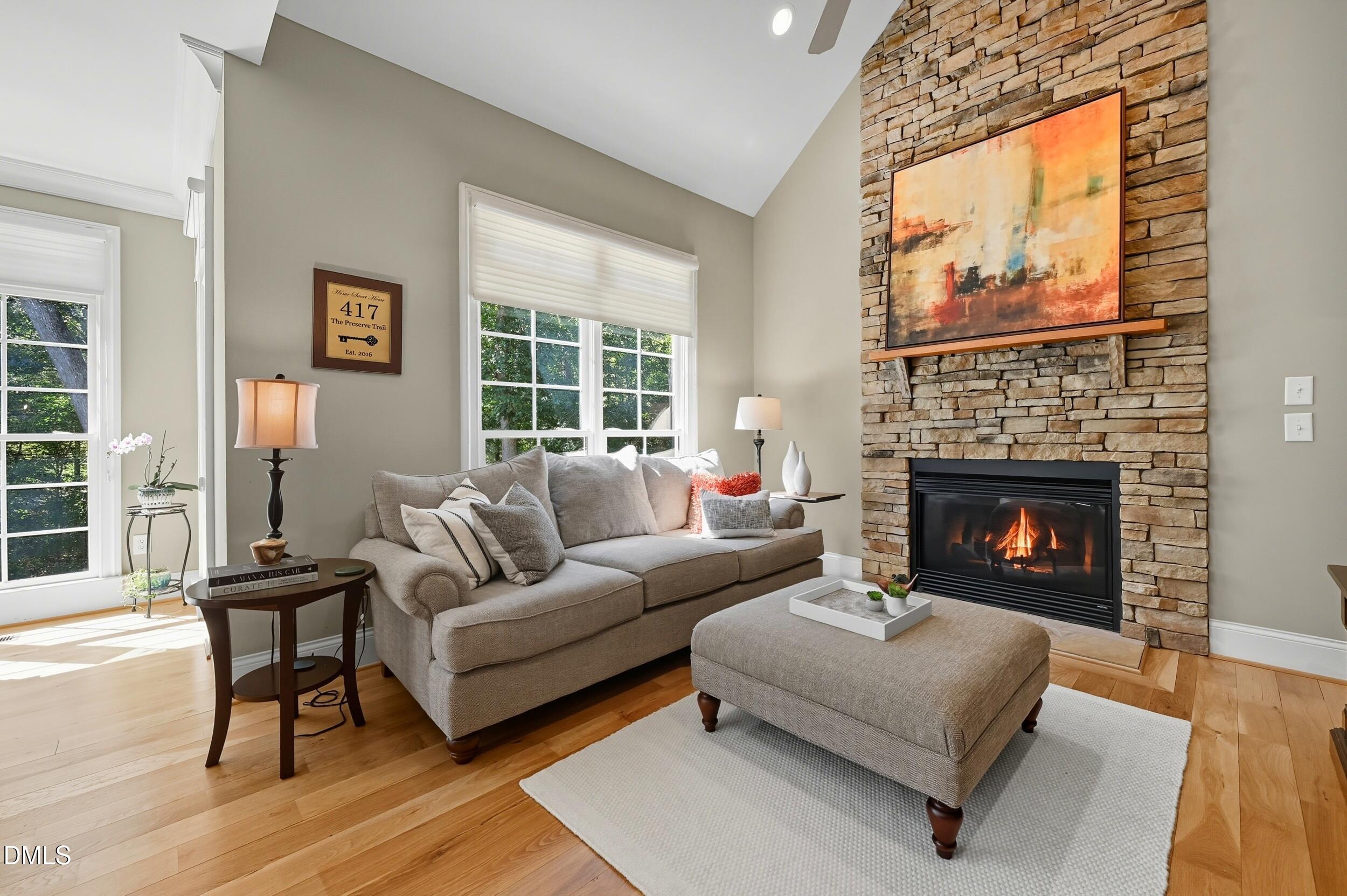 417 The Preserve Trail Chapel Hill, NC 27517 - Photo 27 of 83 a living room with furniture a large window and a fireplace