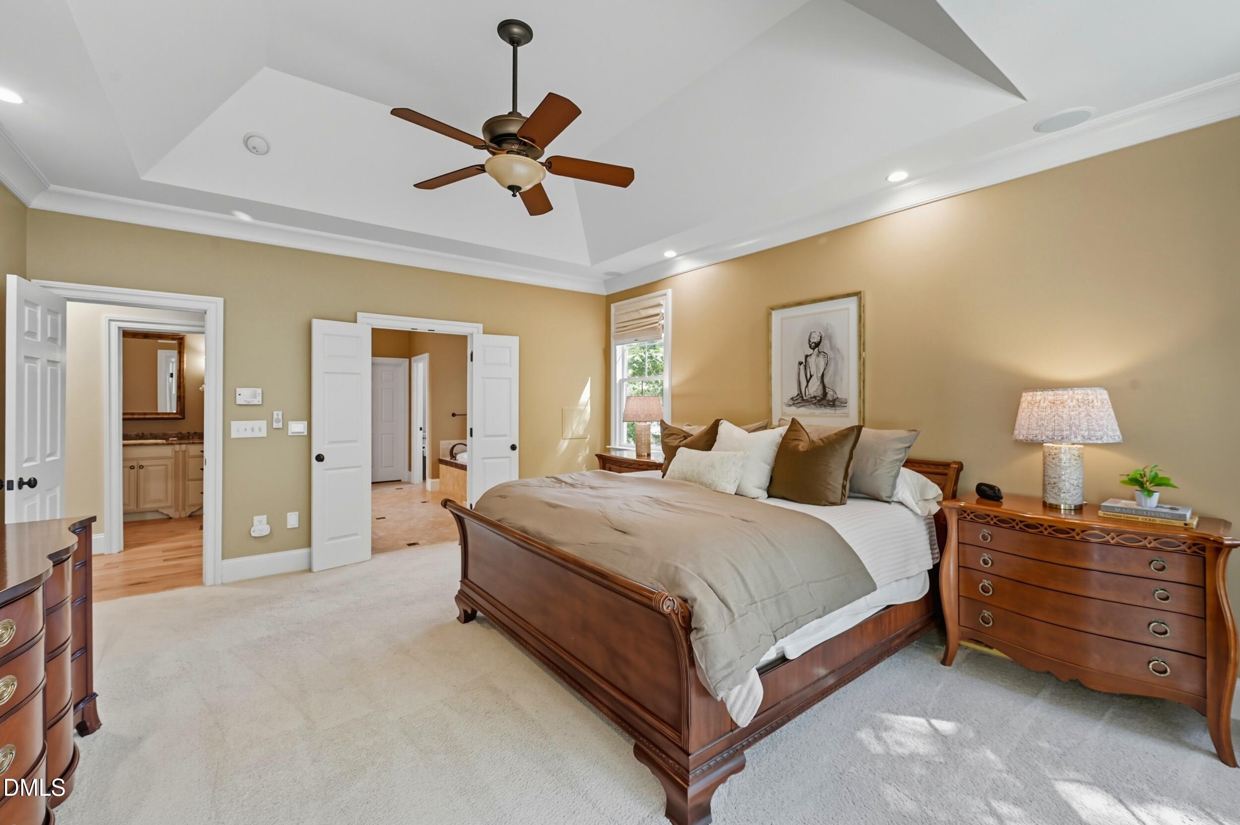 417 The Preserve Trail Chapel Hill, NC 27517 - Photo 29 of 83 a spacious bedroom with a bed and a chandelier