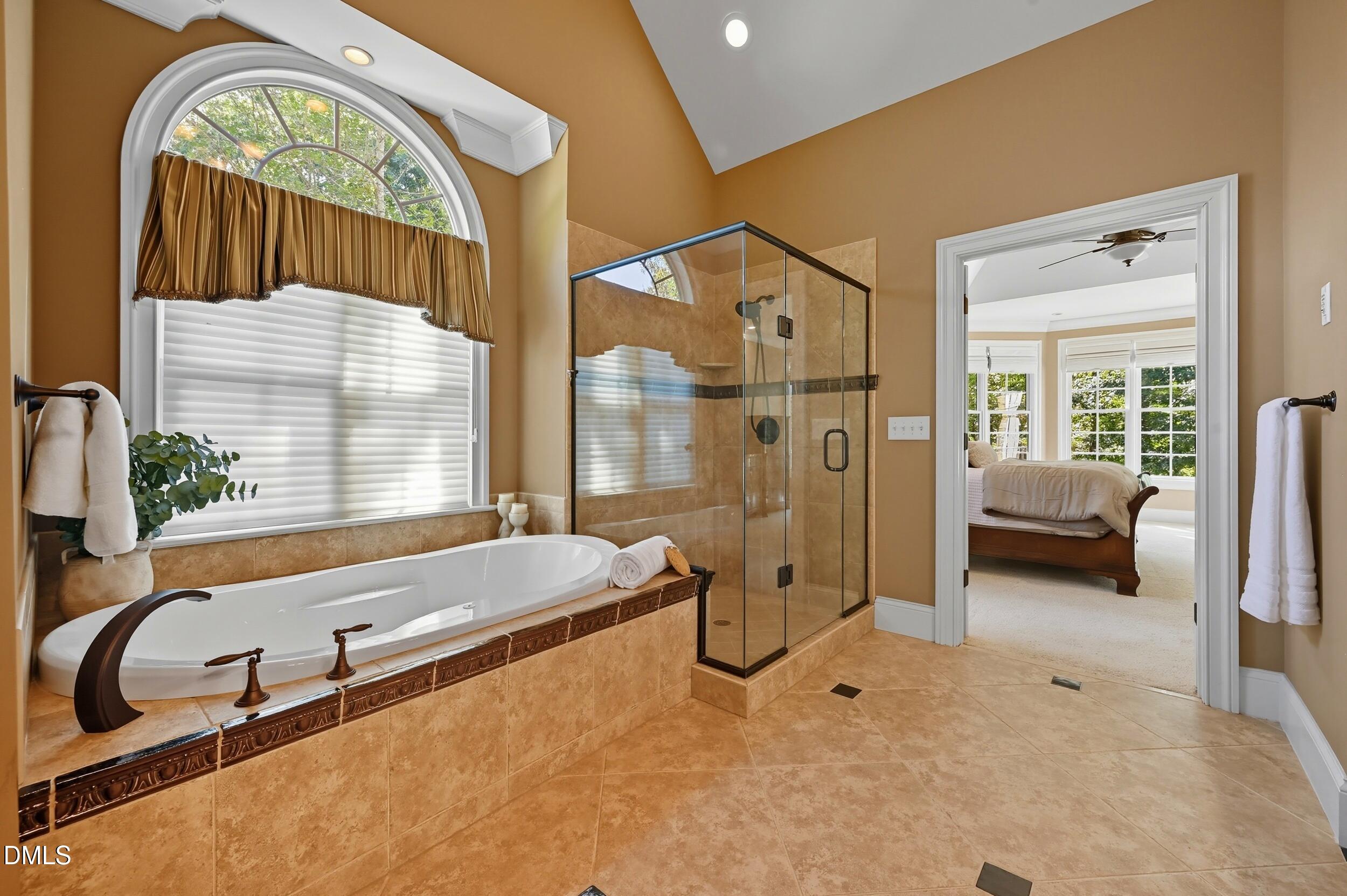 417 The Preserve Trail Chapel Hill, NC 27517 - Photo 32 of 83 a spacious bathroom with a tub and a large mirror