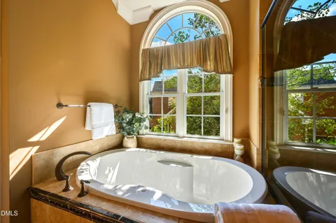 a bedroom with two beds and a chandelier