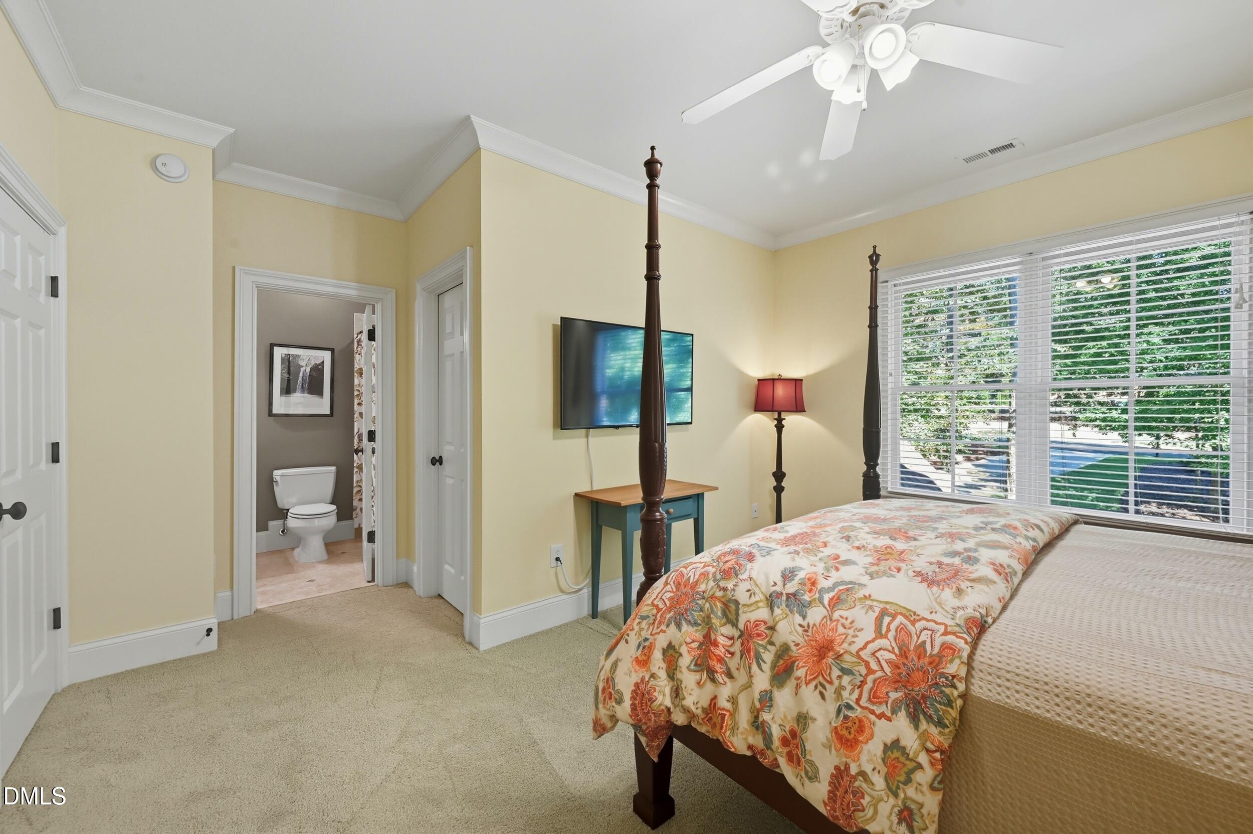 417 The Preserve Trail Chapel Hill, NC 27517 - Photo 40 of 83 a bedroom with a bed and a chandelier