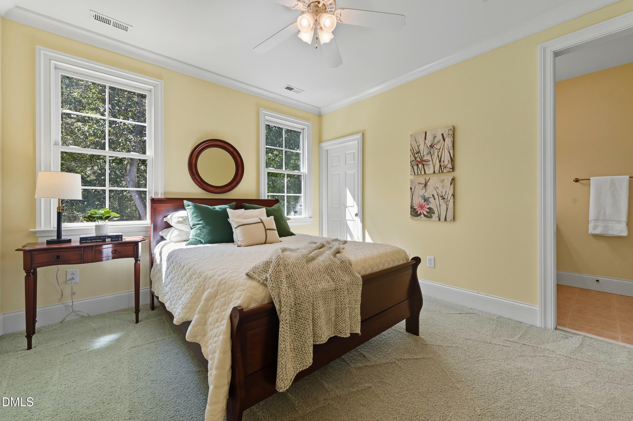 417 The Preserve Trail Chapel Hill, NC 27517 - Photo 41 of 83 a bedroom with a bed and a chandelier