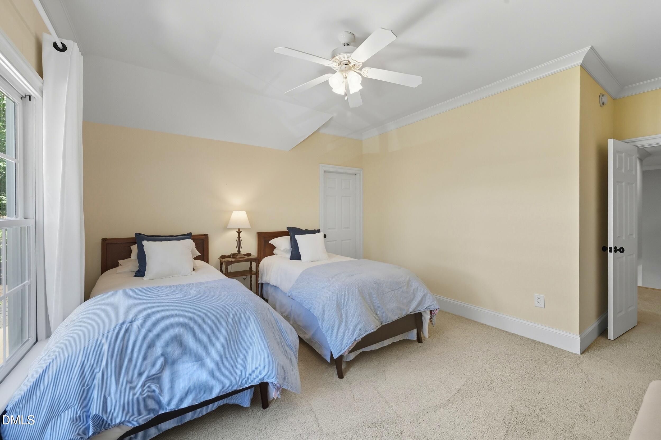 417 The Preserve Trail Chapel Hill, NC 27517 - Photo 44 of 83 a bedroom with two beds and a chandelier