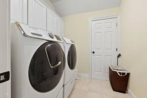 a front view of a house with garden and plants