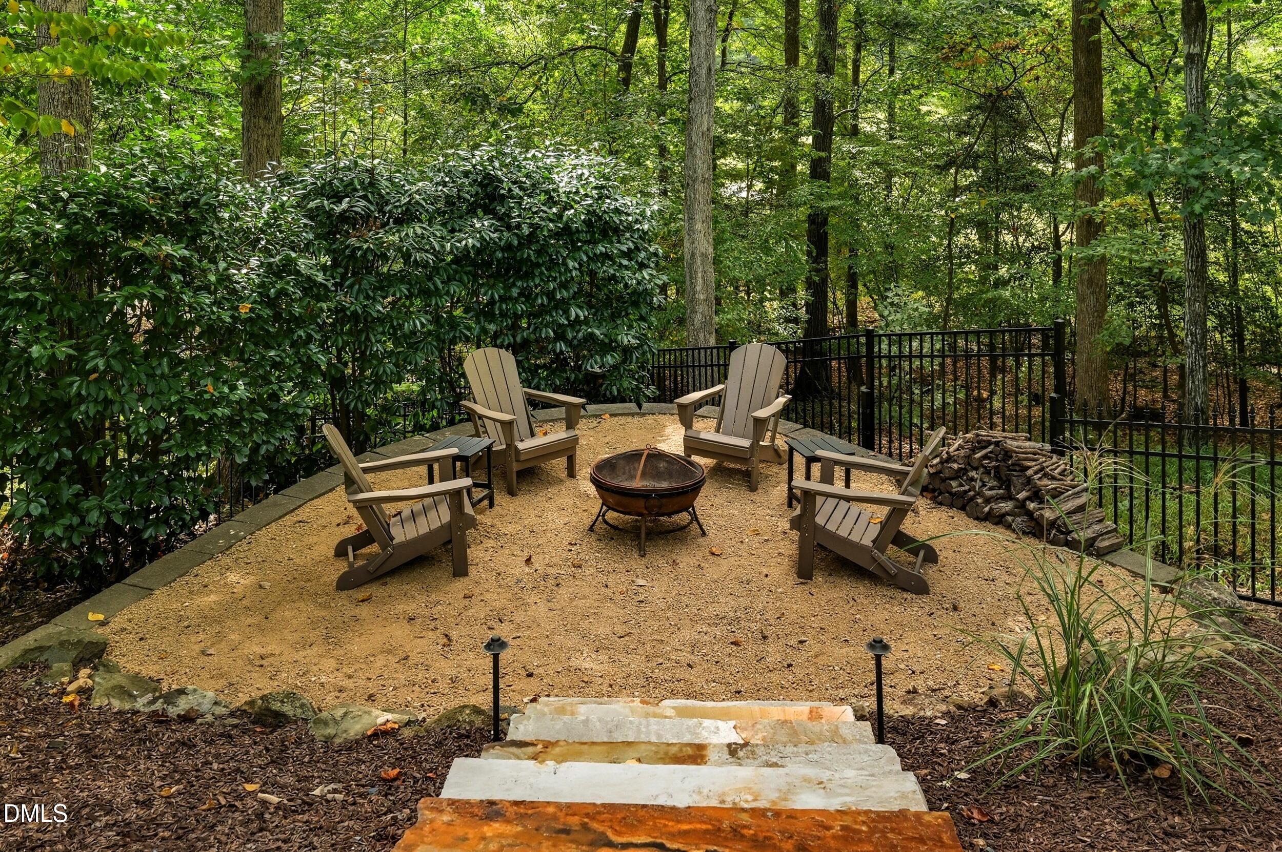 417 The Preserve Trail Chapel Hill, NC 27517 - Photo 66 of 83 a backyard of a house with table and chairs