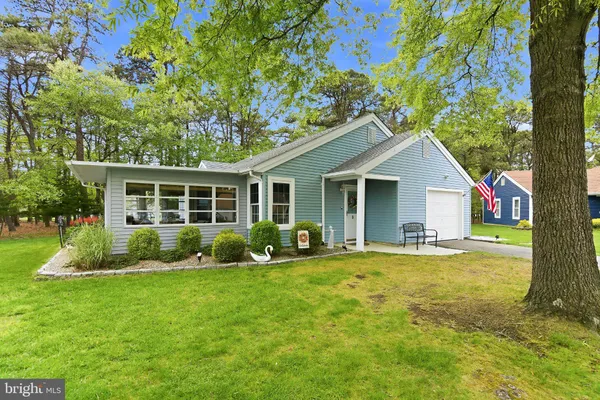 a front view of a house with a yard and porch