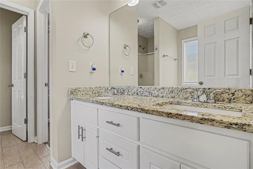10 Wilbur Way Covington, GA 30016 - Photo 8 of 22 a bathroom with a granite countertop sink and a mirror
