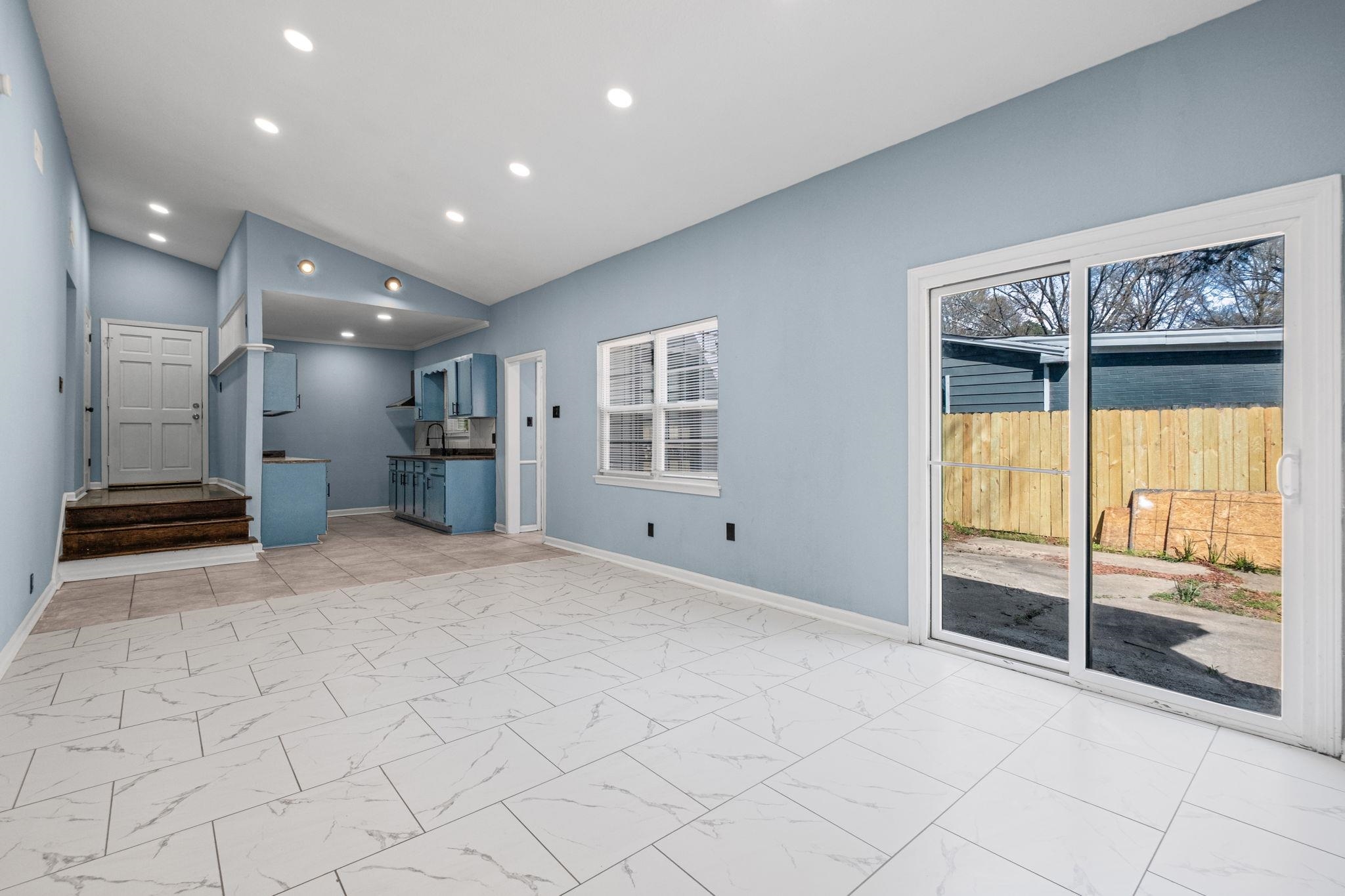 3793 Tessland Road Memphis, TN 38128 - Photo 12 of 22 Unfurnished living room featuring lofted ceiling, healthy amount of natural light, recessed lighting, and light marble finish floors