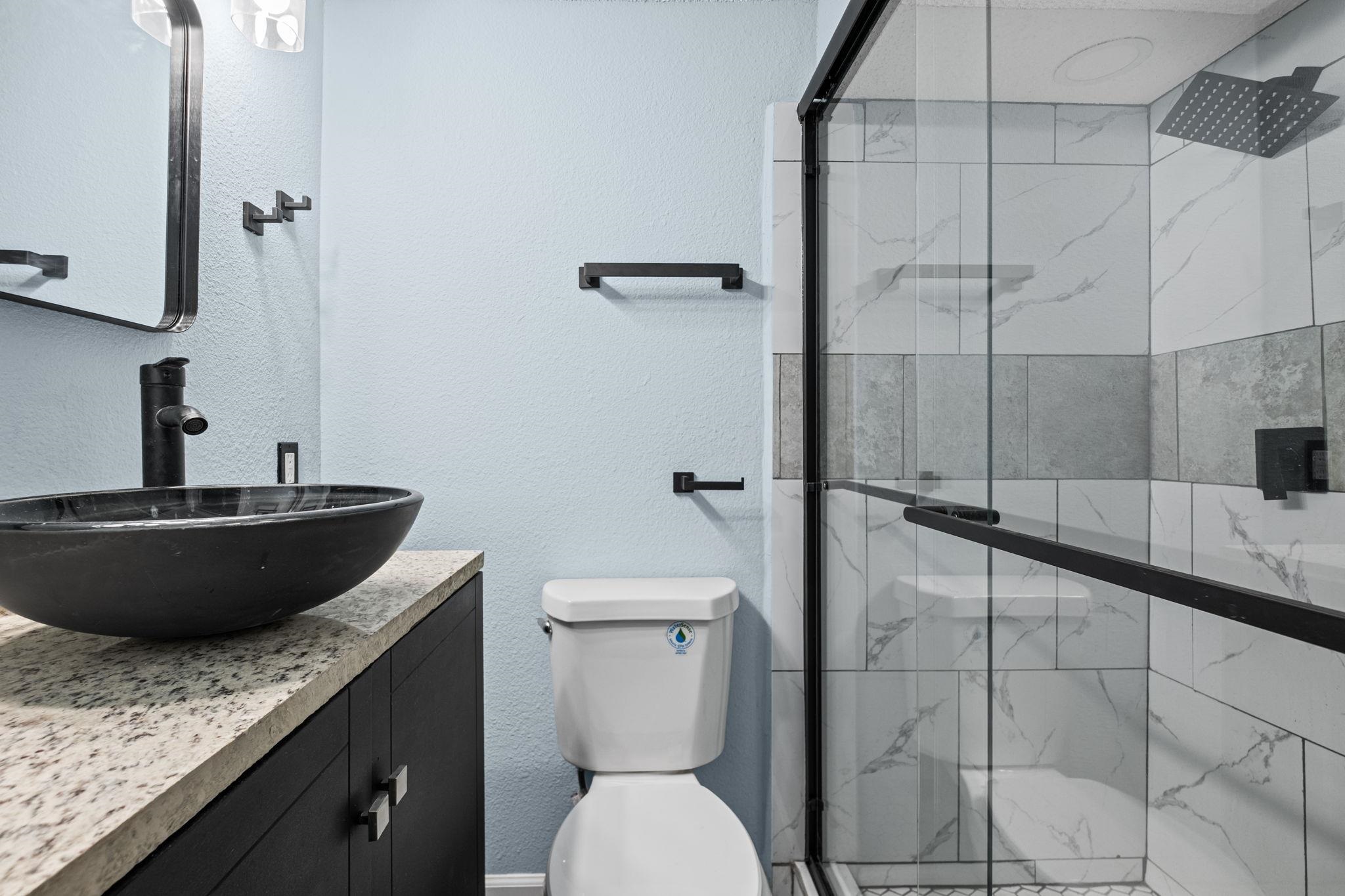 3793 Tessland Road Memphis, TN 38128 - Photo 17 of 22 Full bath featuring a marble finish shower, vanity, and a textured wall