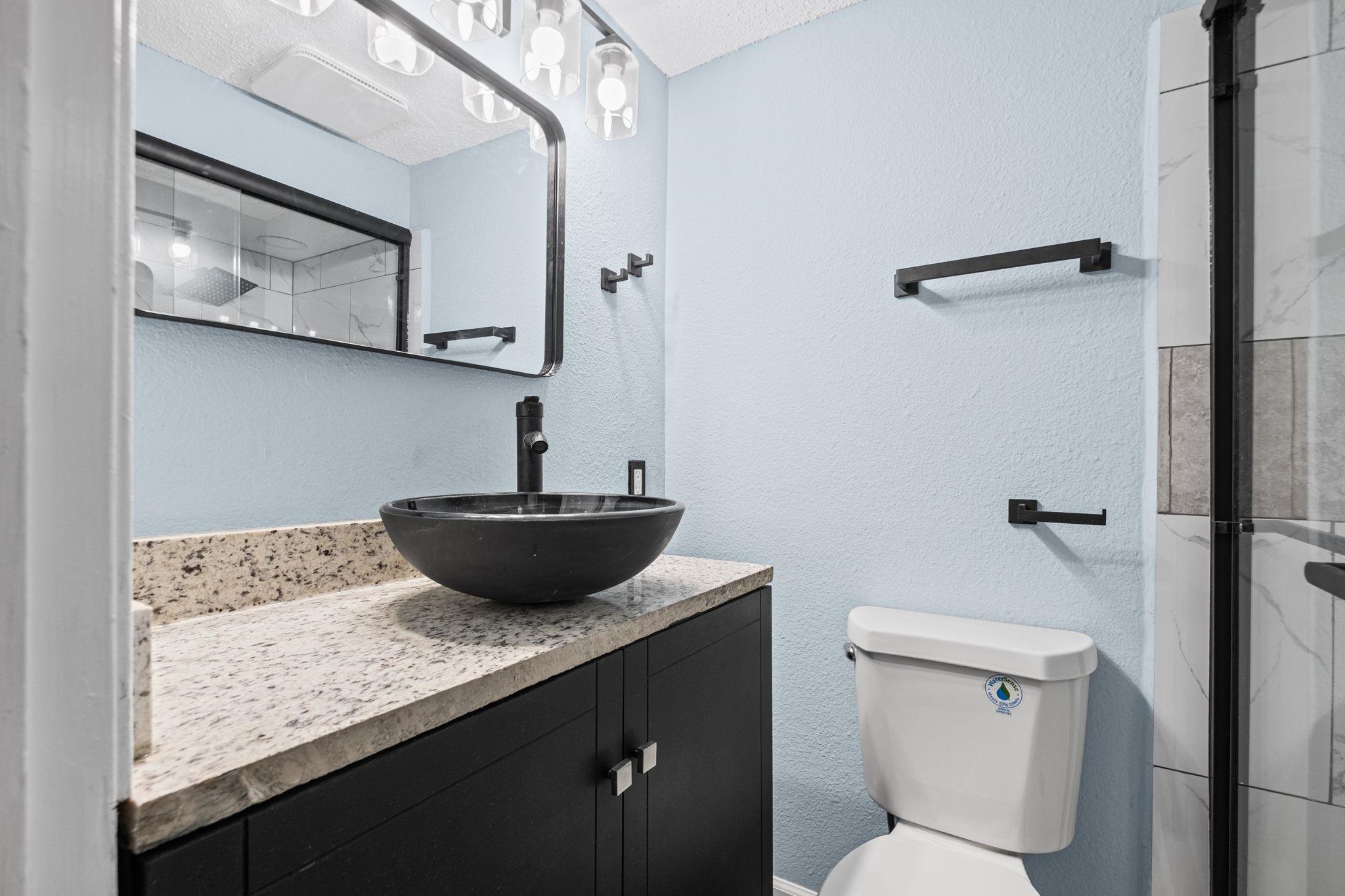 3793 Tessland Road Memphis, TN 38128 - Photo 18 of 22 Full bathroom with vanity, a textured wall, and a stall shower
