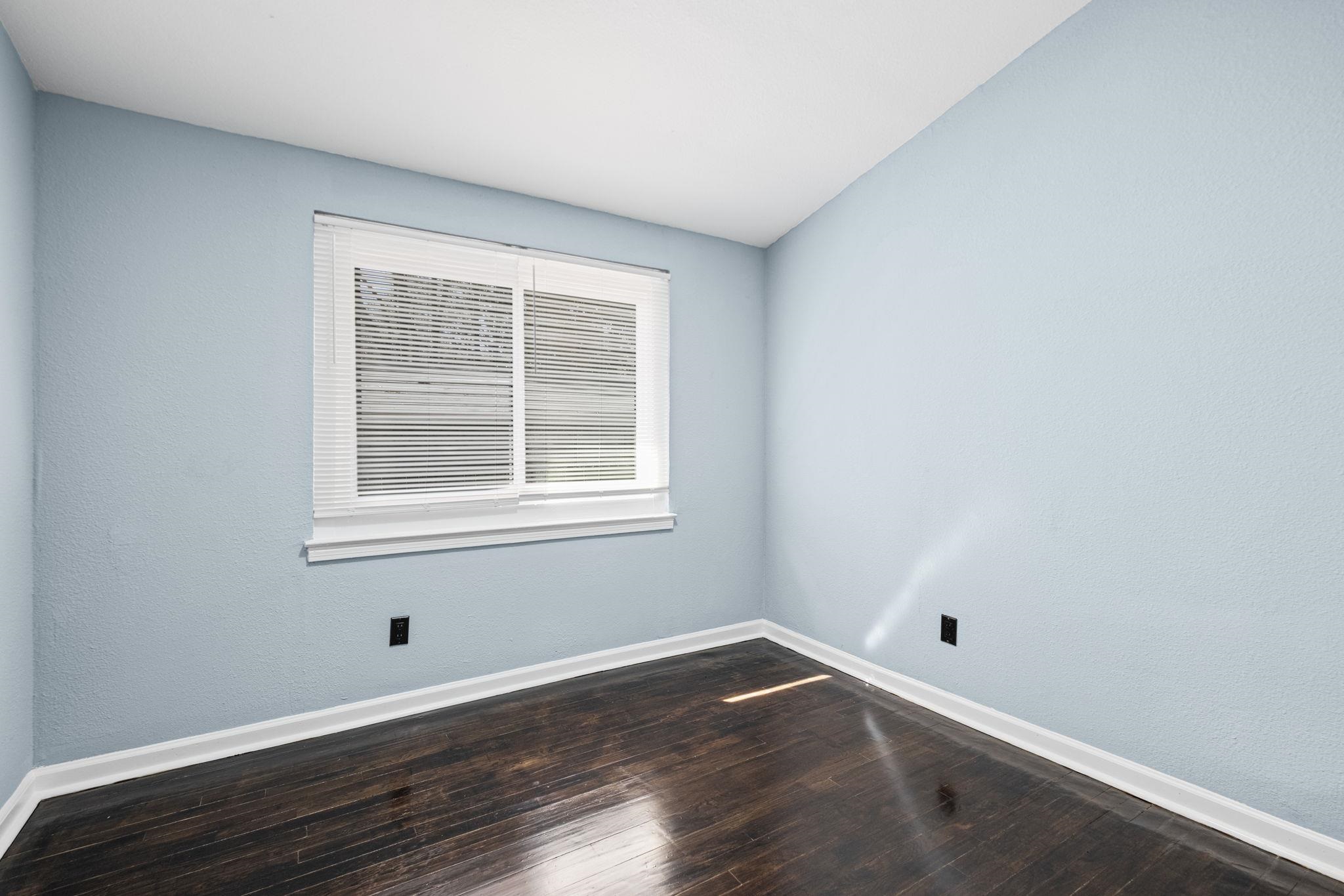 3793 Tessland Road Memphis, TN 38128 - Photo 19 of 22 Unfurnished room with dark wood finished floors, vaulted ceiling, and a textured wall