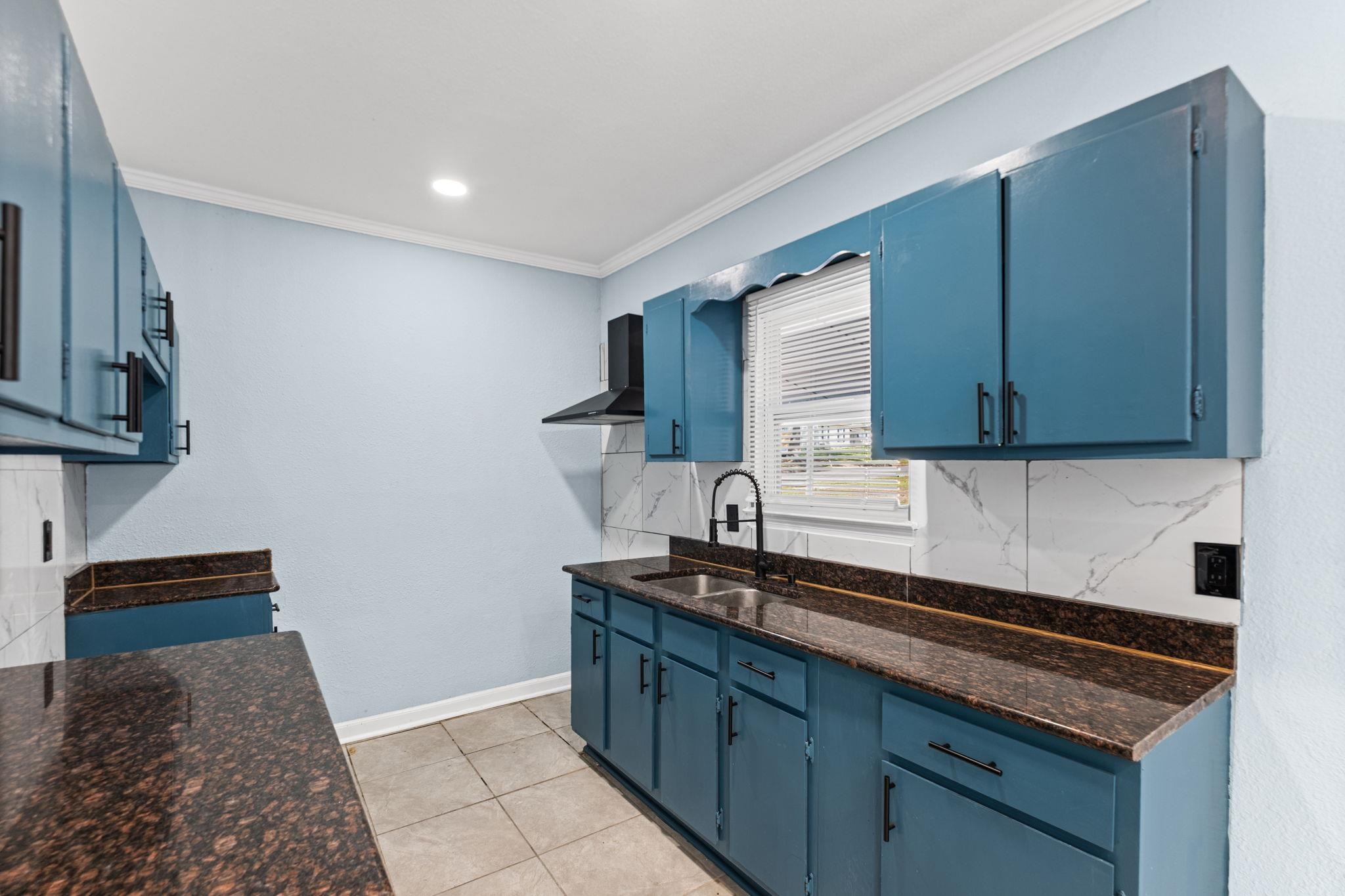 3793 Tessland Road Memphis, TN 38128 - Photo 6 of 22 Kitchen with blue cabinets, backsplash, crown molding, dark stone counters, and recessed lighting