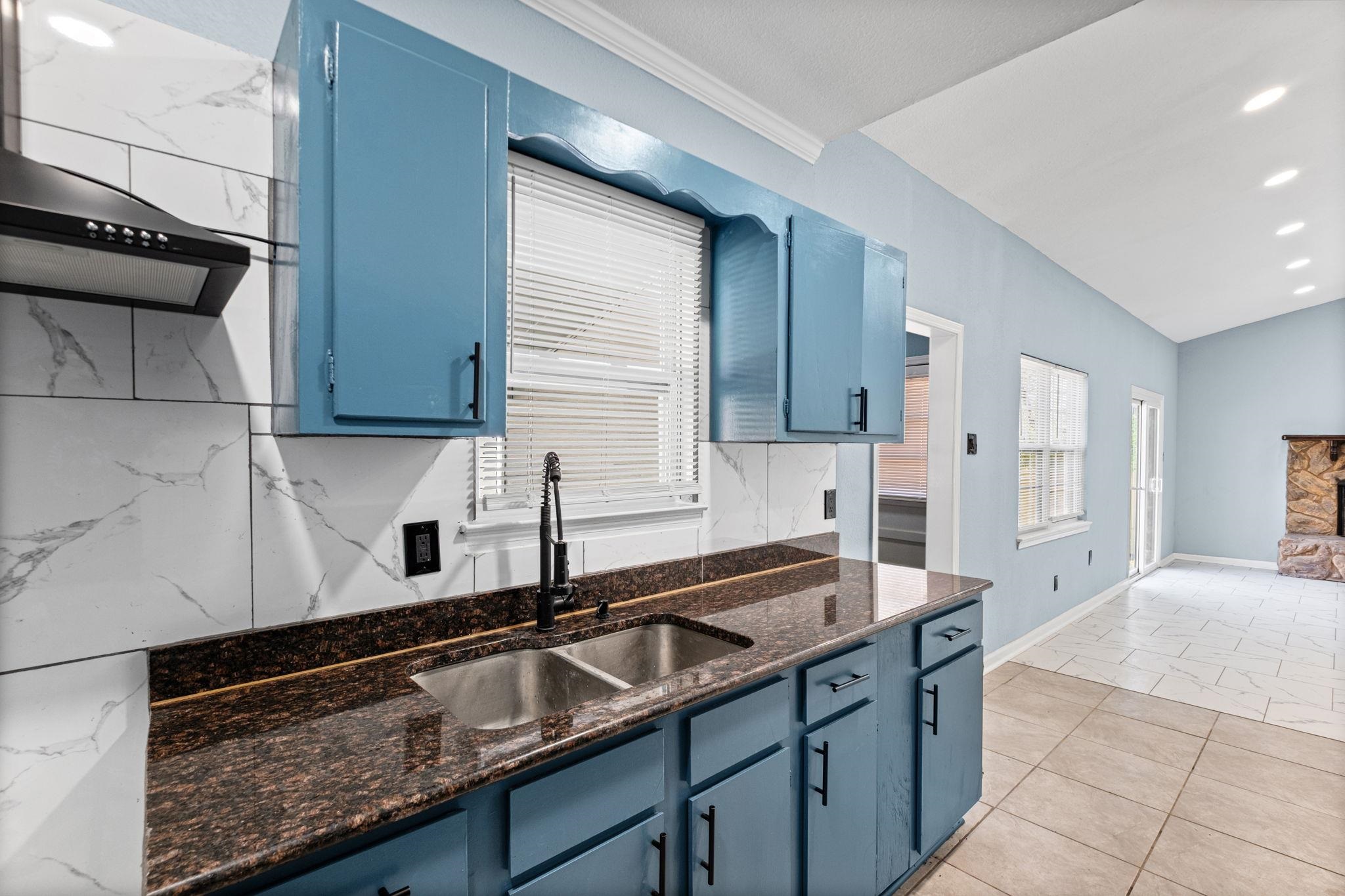 3793 Tessland Road Memphis, TN 38128 - Photo 8 of 22 Kitchen featuring blue cabinetry, extractor fan, dark stone countertops, and tasteful backsplash