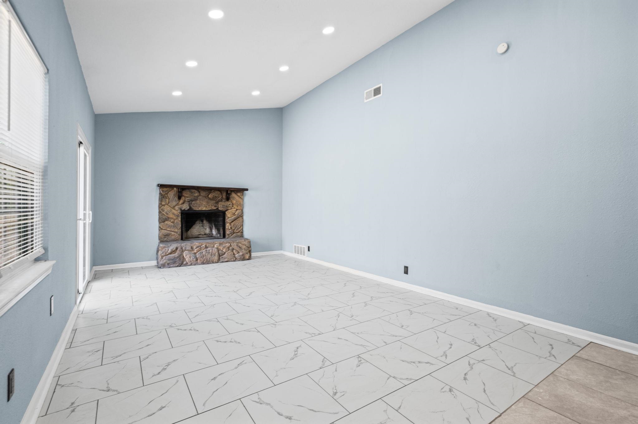 3793 Tessland Road Memphis, TN 38128 - Photo 10 of 22 Unfurnished living room with a fireplace, recessed lighting, and light marble finish flooring