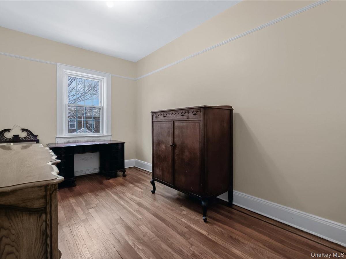 140-17 58th Road Queens, NY 11355 - Photo 15 of 25 a view of a livingroom with wooden floor and a workspace
