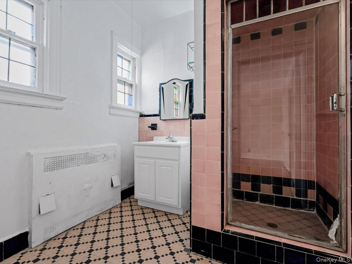 140-17 58th Road Queens, NY 11355 - Photo 16 of 25 a bathroom with a sink a toilet and shower