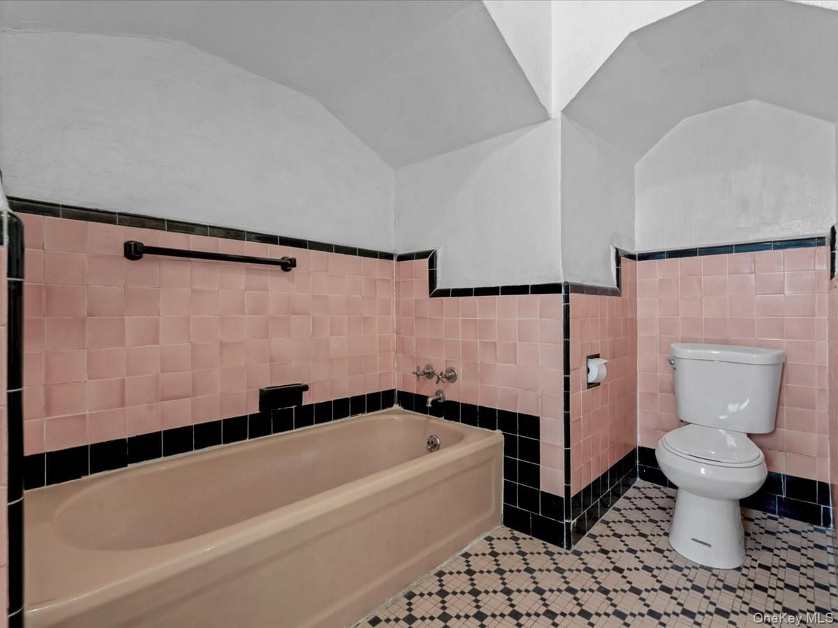 140-17 58th Road Queens, NY 11355 - Photo 17 of 25 a bathroom with a bathtub and a toilet
