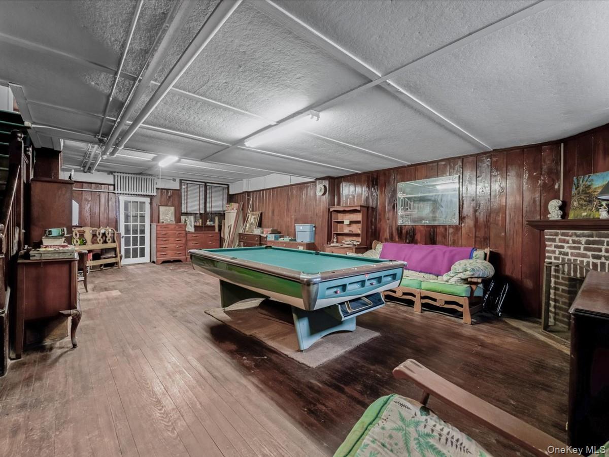 140-17 58th Road Queens, NY 11355 - Photo 18 of 25 a room with furniture and a wooden floor