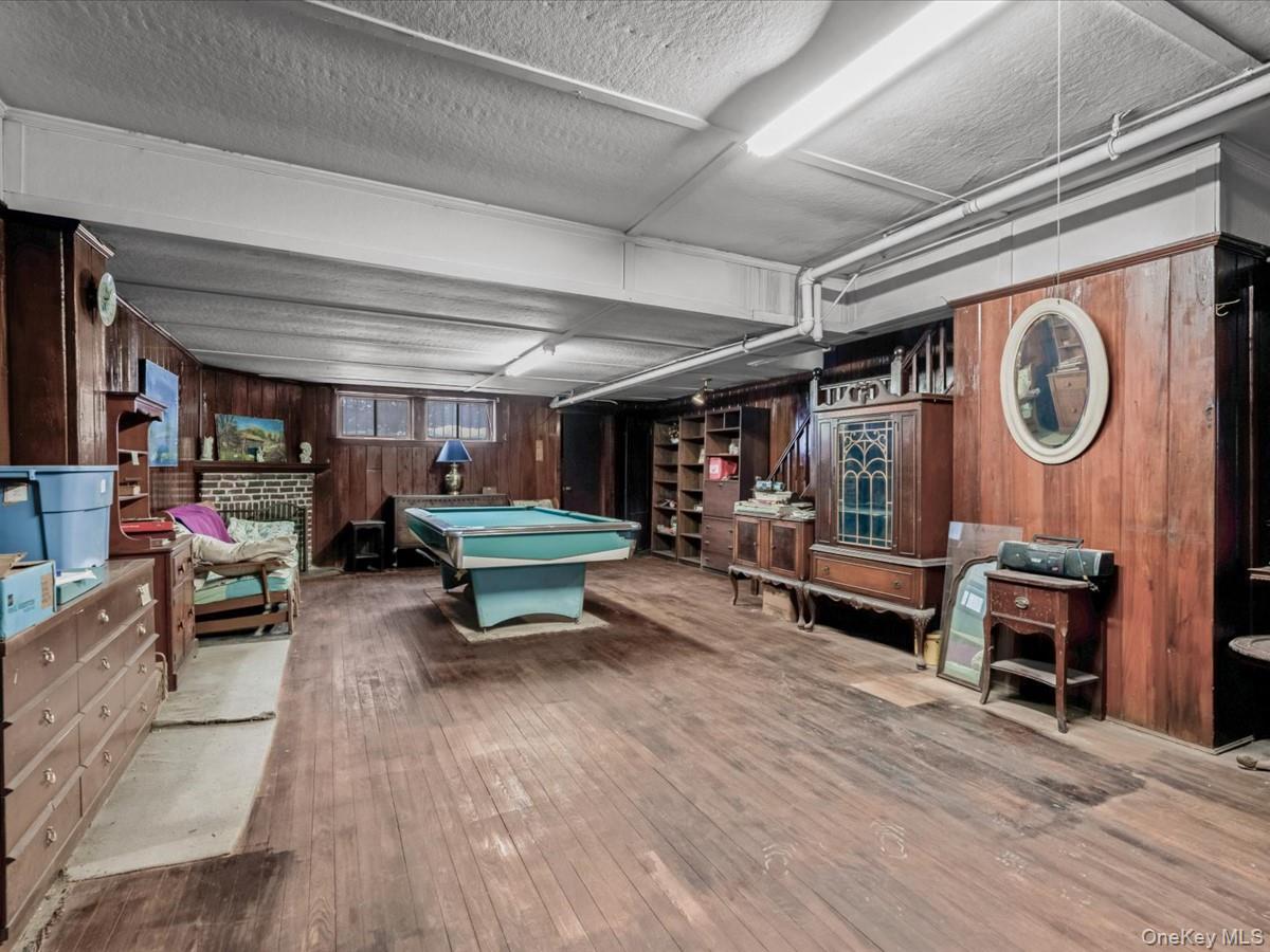 140-17 58th Road Queens, NY 11355 - Photo 19 of 25 a living room with furniture and a wooden floors