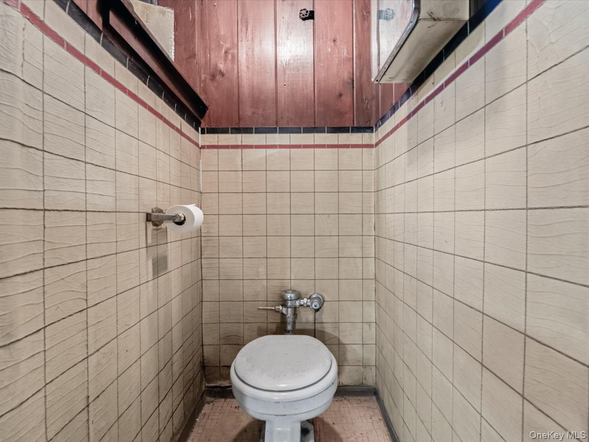 140-17 58th Road Queens, NY 11355 - Photo 20 of 25 a bathroom with a toilet and a shower