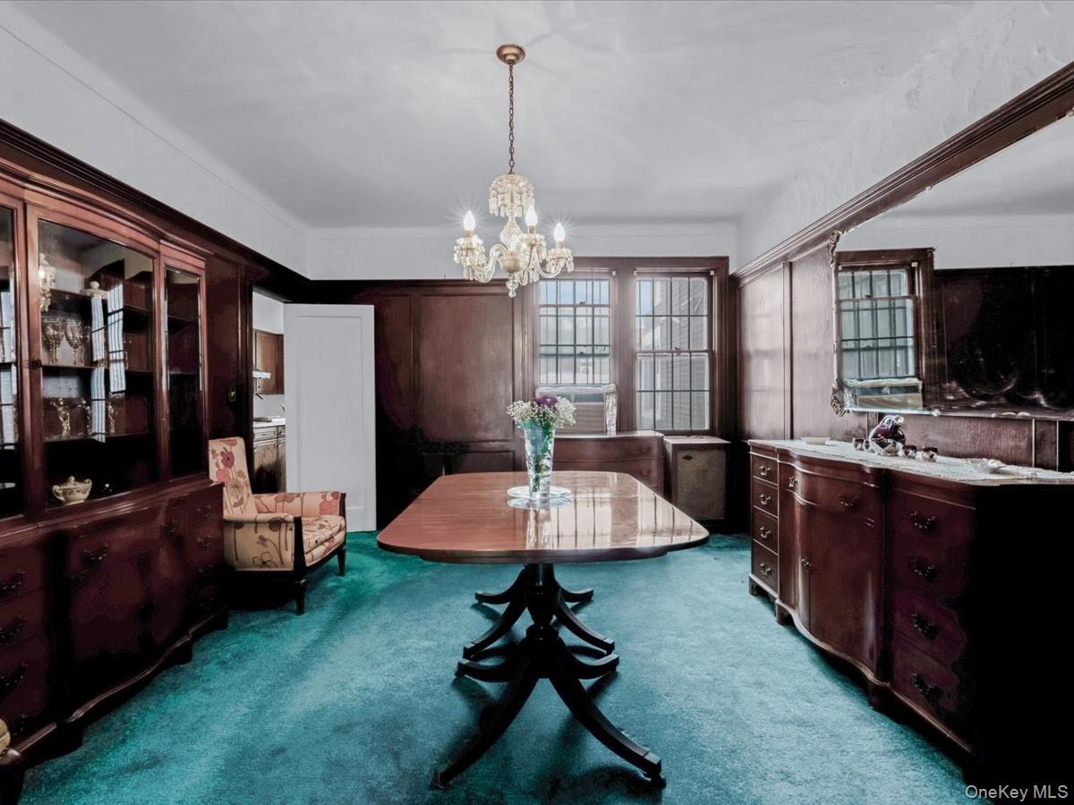140-17 58th Road Queens, NY 11355 - Photo 5 of 25 a living room with furniture and a chandelier