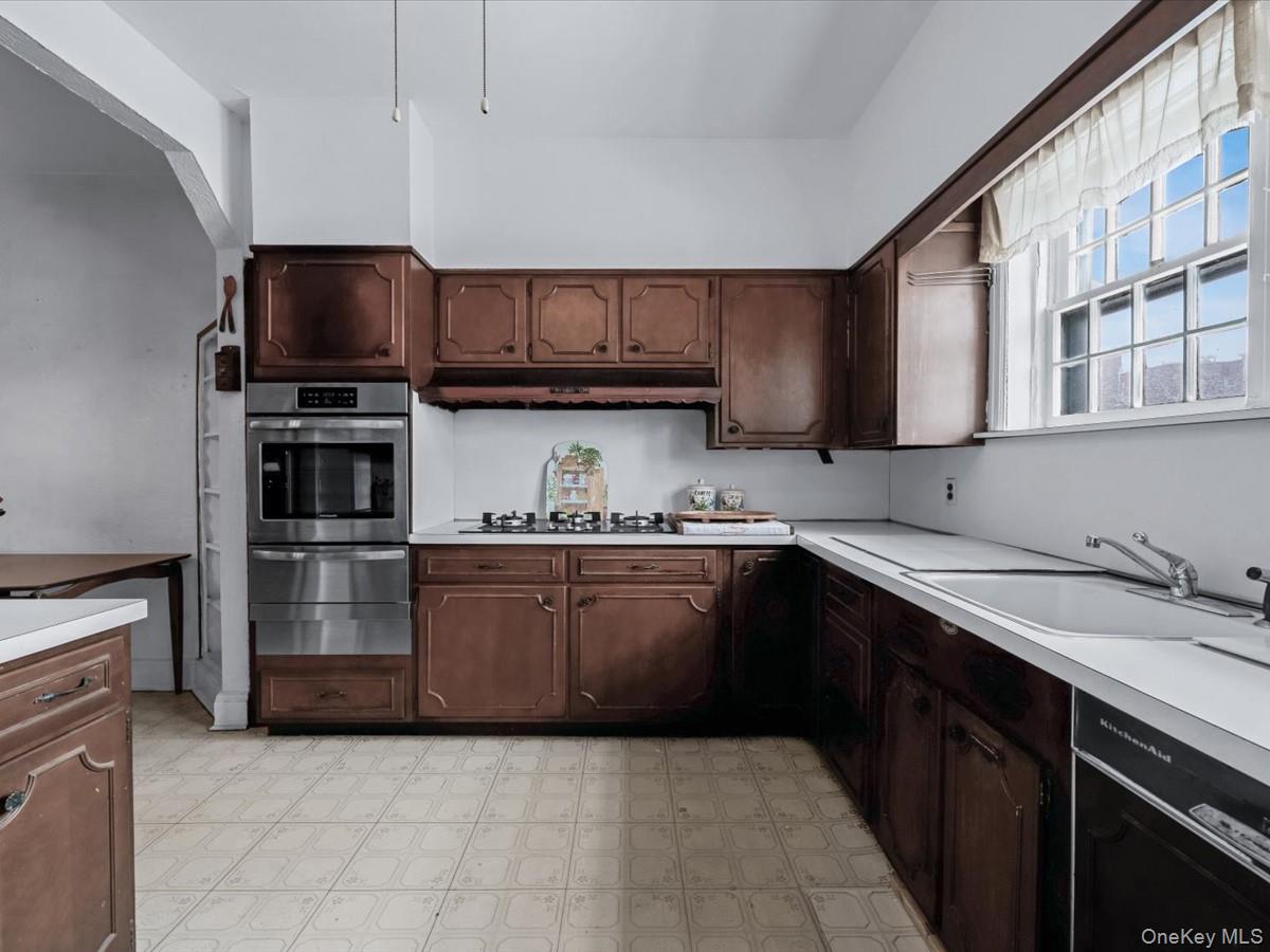 140-17 58th Road Queens, NY 11355 - Photo 10 of 25 a kitchen with stainless steel appliances granite countertop a refrigerator and a sink