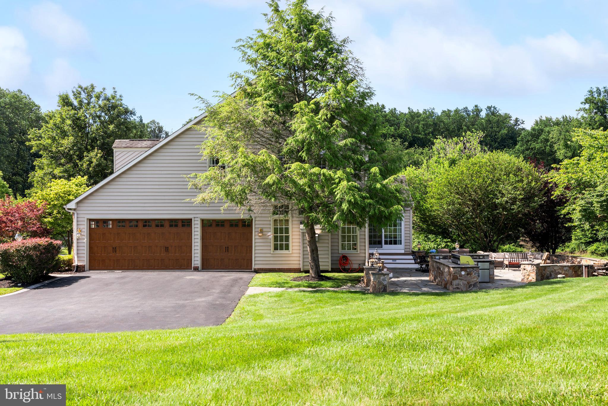 7 Redtree Lane Reisterstown, MD 21136 - Photo 2 of 56 a backyard of a house with table and chairs plants and large tree
