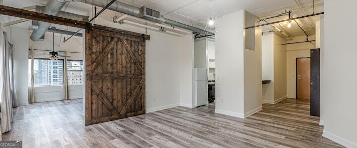 a view of a bathroom with wooden floor and a shower