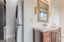 120 Ralph McGill Boulevard Northeast, Unit 1302 Atlanta, GA 30308 - Photo 22 of 28 a bathroom with a sink vanity and a mirror