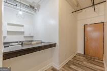 120 Ralph McGill Boulevard Northeast, Unit 1302 Atlanta, GA 30308 - Photo 4 of 28 a kitchen with a sink and a refrigerator