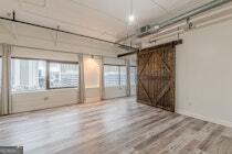 120 Ralph McGill Boulevard Northeast, Unit 1302 Atlanta, GA 30308 - Photo 6 of 28 a view of empty room with wooden floor and fan