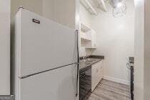 120 Ralph McGill Boulevard Northeast, Unit 1302 Atlanta, GA 30308 - Photo 10 of 28 a kitchen with a stove and a refrigerator
