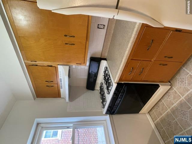 279 Chestnut Street Nutley, NJ 07110 - Photo 4 of 9 a kitchen with a stove and a cabinet