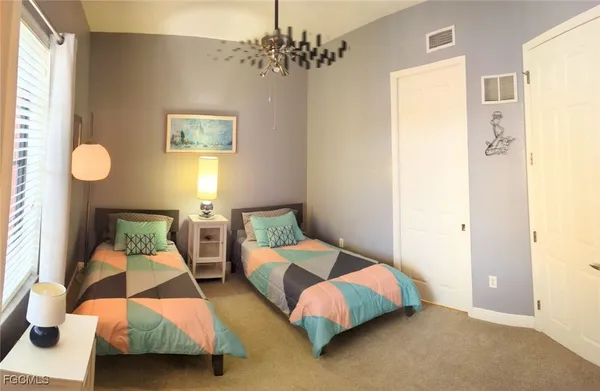 a bedroom with two beds and painted walls