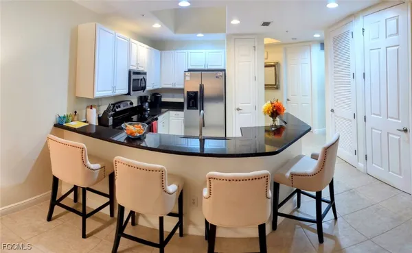 a living room with furniture and kitchen view
