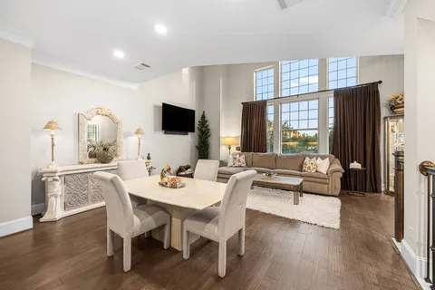 a dining room with furniture window and wooden floor