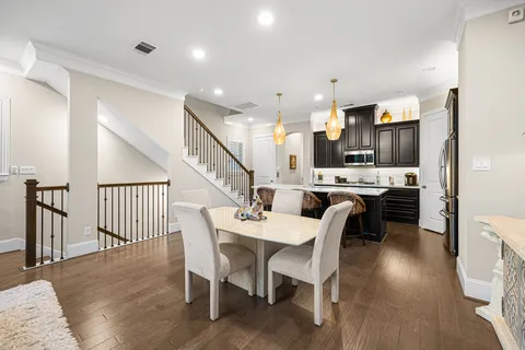 a large kitchen with a table and chairs