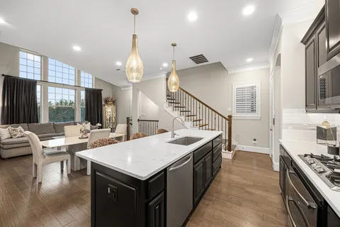 a kitchen with sink stove and cabinets