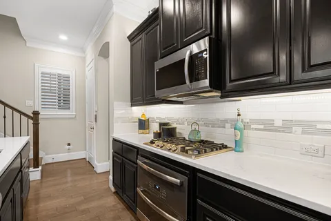 a kitchen with stainless steel appliances a stove microwave and cabinets