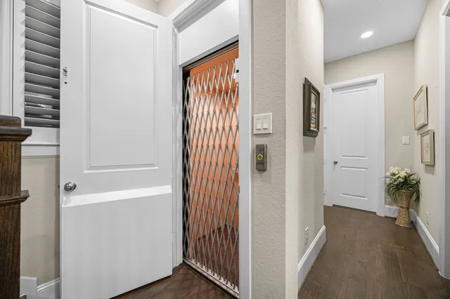 a view of a hallway with bathroom and front door