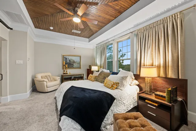 a bedroom with bed couch and window