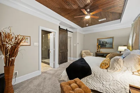 a bedroom with furniture and a large window