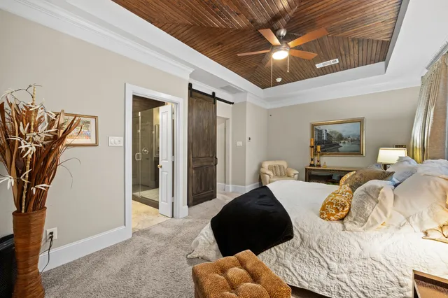a bedroom with furniture and a large window