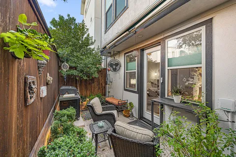 a backyard of a house with outdoor seating