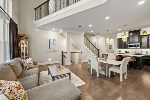 a living room with furniture and kitchen view